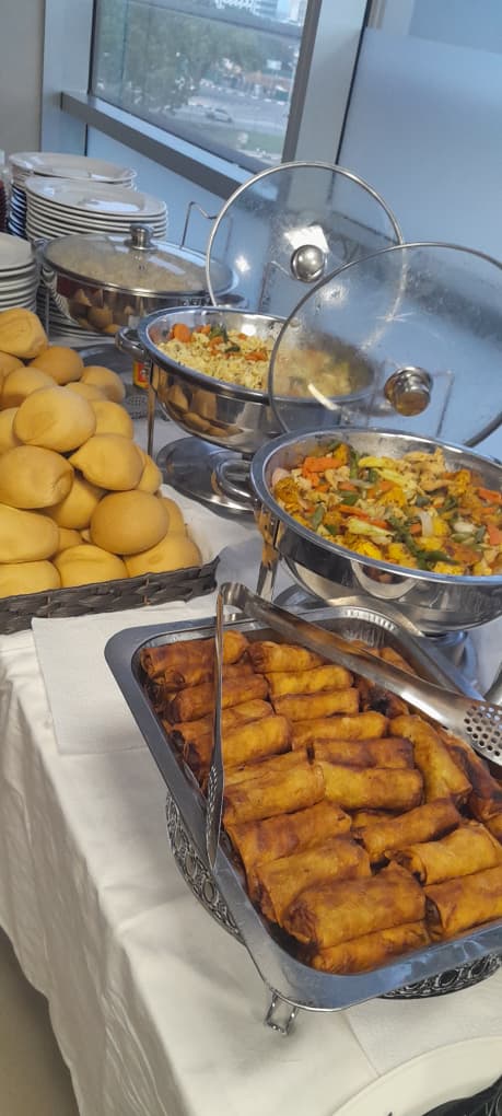 Breakfast buffet spread with spring rolls and salad
