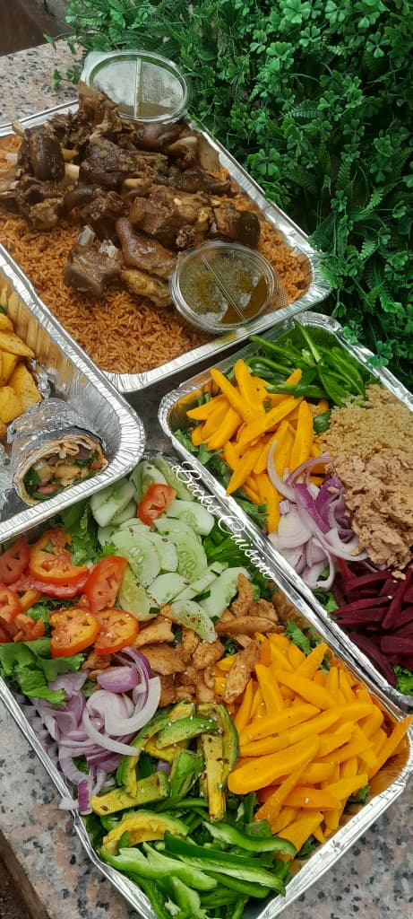Full food platter with jollof rice and salad